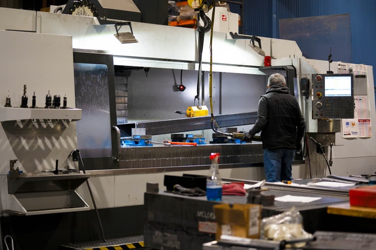 worker in front of large envelope 3-axis mill